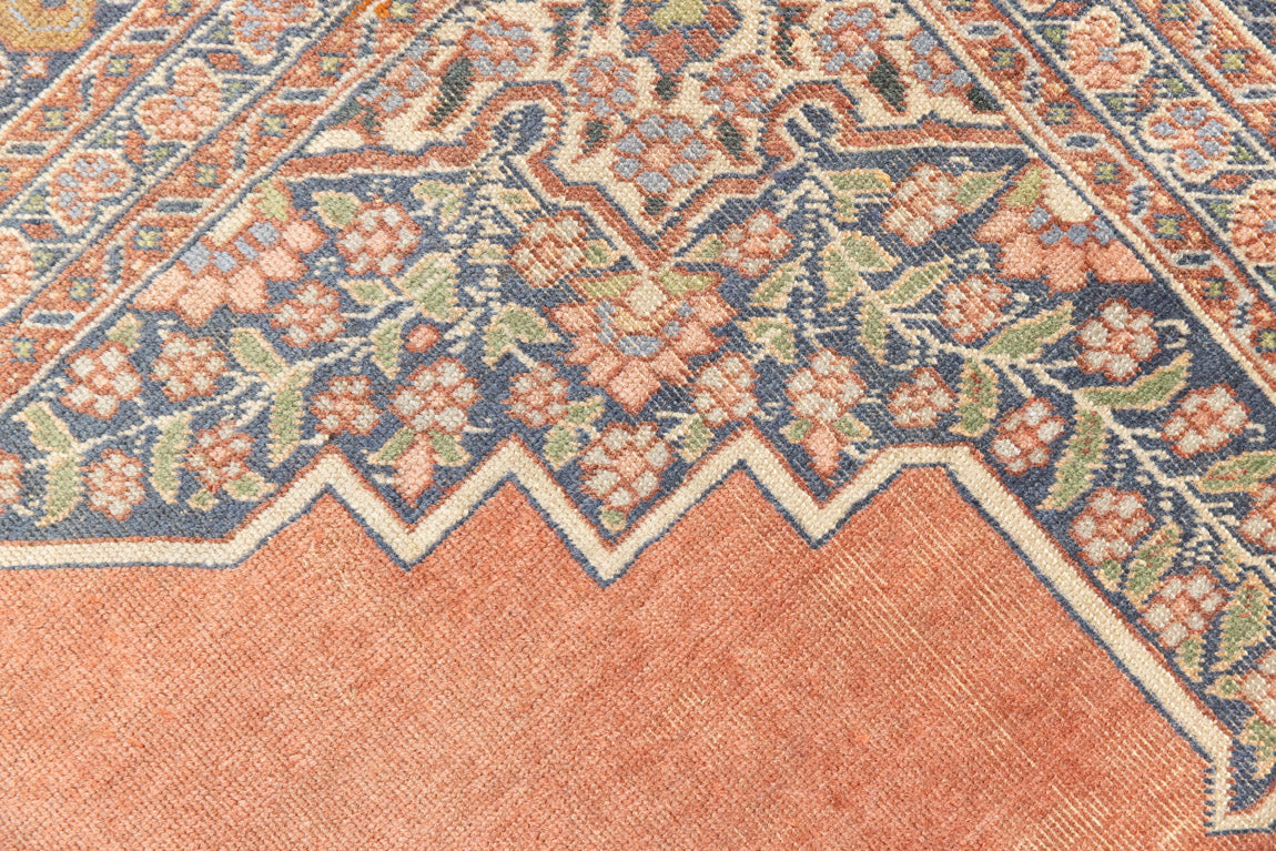 Selma is a beautiful antique Persian Tabriz rug with a soft yet bold coral colour palette and a stunning abrash and patina with a lovely central medallion within the carpet.