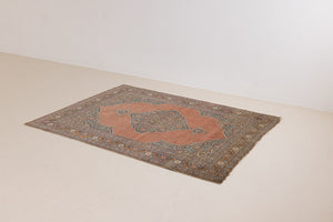 Selma is a beautiful antique Persian Tabriz rug with a soft yet bold coral colour palette and a stunning abrash and patina with a lovely central medallion within the carpet.