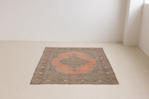 Selma is a beautiful antique Persian Tabriz rug with a soft yet bold coral colour palette and a stunning abrash and patina with a lovely central medallion within the carpet.