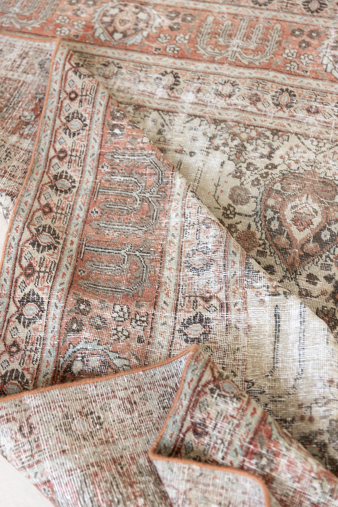 This is a handmade antique Tabriz rug woven in Persia. The Tabriz region is known for producing some of the most ornate Persian carpet, often known for their mesmerising and intricate repeating patterns.