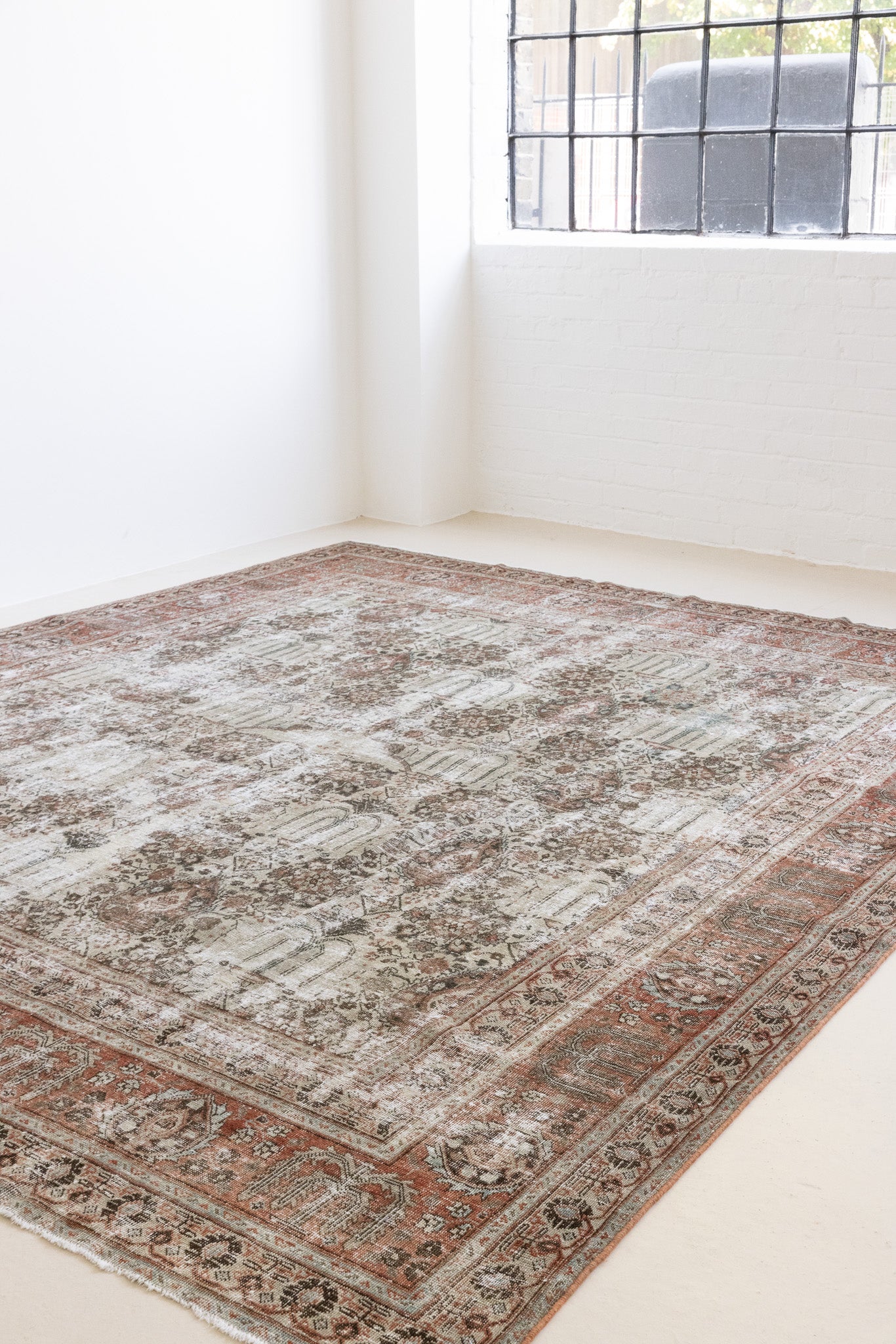 This is a handmade antique Tabriz rug woven in Persia. The Tabriz region is known for producing some of the most ornate Persian carpet, often known for their mesmerising and intricate repeating patterns.