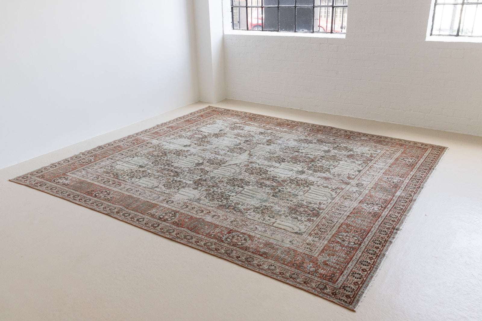 This is a handmade antique Tabriz rug woven in Persia. The Tabriz region is known for producing some of the most ornate Persian carpet, often known for their mesmerising and intricate repeating patterns.