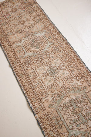 Bonnie is an vintage Persian Heriz runner rug which has been antique washed using a special technique to gently fade its original colours, creating a stunning muted palette. Heriz rugs are some of the most sought after Persian carpets and this one features a classic Heriz design in gorgeous soft blue, taupe and cream tones. 