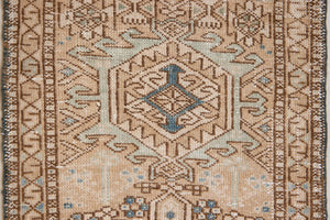 Bonnie is an vintage Persian Heriz runner rug which has been antique washed using a special technique to gently fade its original colours, creating a stunning muted palette. Heriz rugs are some of the most sought after Persian carpets and this one features a classic Heriz design in gorgeous soft blue, taupe and cream tones. 