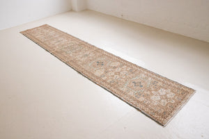 Bonnie is an vintage Persian Heriz runner rug which has been antique washed using a special technique to gently fade its original colours, creating a stunning muted palette. Heriz rugs are some of the most sought after Persian carpets and this one features a classic Heriz design in gorgeous soft blue, taupe and cream tones. 