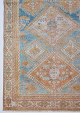 Odessa is a small antique Persian Mahal rug featuring a blue and rust coloured pattern.