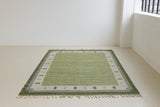  Lilo is an original vintage Swedish röllakan rug from around the 1960s, featuring wonderful palette of various shades of green and ecru tones and a beautifully simple design.