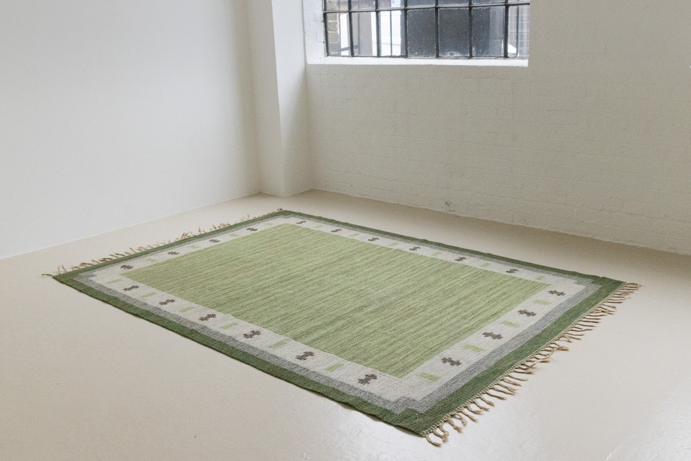  Lilo is an original vintage Swedish röllakan rug from around the 1960s, featuring wonderful palette of various shades of green and ecru tones and a beautifully simple design.