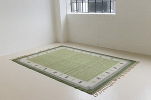  Lilo is an original vintage Swedish röllakan rug from around the 1960s, featuring wonderful palette of various shades of green and ecru tones and a beautifully simple design.