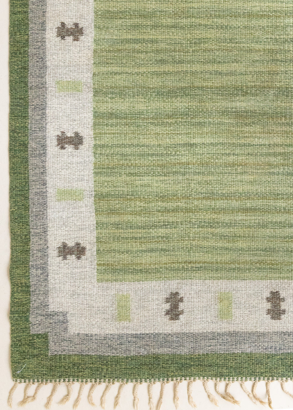 Lilo is an original vintage Swedish röllakan rug from around the 1960s, featuring wonderful palette of various shades of green and ecru tones and a beautifully simple design.