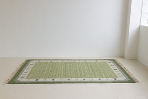  Lilo is an original vintage Swedish röllakan rug from around the 1960s, featuring wonderful palette of various shades of green and ecru tones and a beautifully simple design.