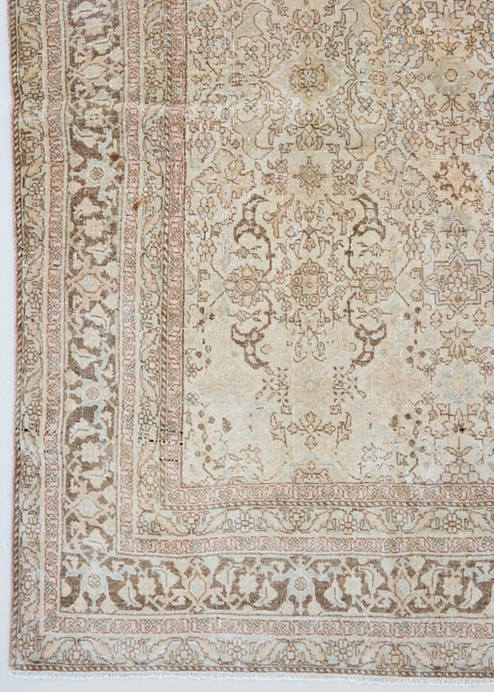 Cecil is a beautiful antique Persian Tabriz rug with a soft and subtle colour palette and in an extra large size. This pretty carpet features highly detailed flowers, palmettes, arabesques and leafy sprays throughout the field and borders, symbolising nature and beauty.