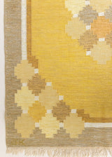 This is an original vintage Swedish flat weave carpet signed by the renowned textile designer Karin Jonsson. This rug features a palette of rich ochre yellow and a beautiful geometric design. 