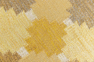 This is an original vintage Swedish flat weave carpet signed by the renowned textile designer Karin Jonsson. This rug features a palette of rich ochre yellow and a beautiful geometric design. 