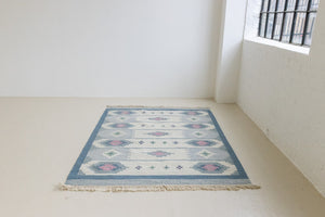 This rug shows beautiful tones of blue, this vintage kilim is featuring bold geometric design with hints of pink within the motifs in the carpet. 