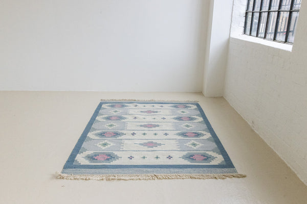 This rug shows beautiful tones of blue, this vintage kilim is featuring bold geometric design with hints of pink within the motifs in the carpet. 