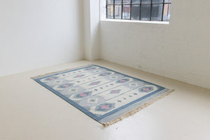 This rug shows beautiful tones of blue, this vintage kilim is featuring bold geometric design with hints of pink within the motifs in the carpet. 