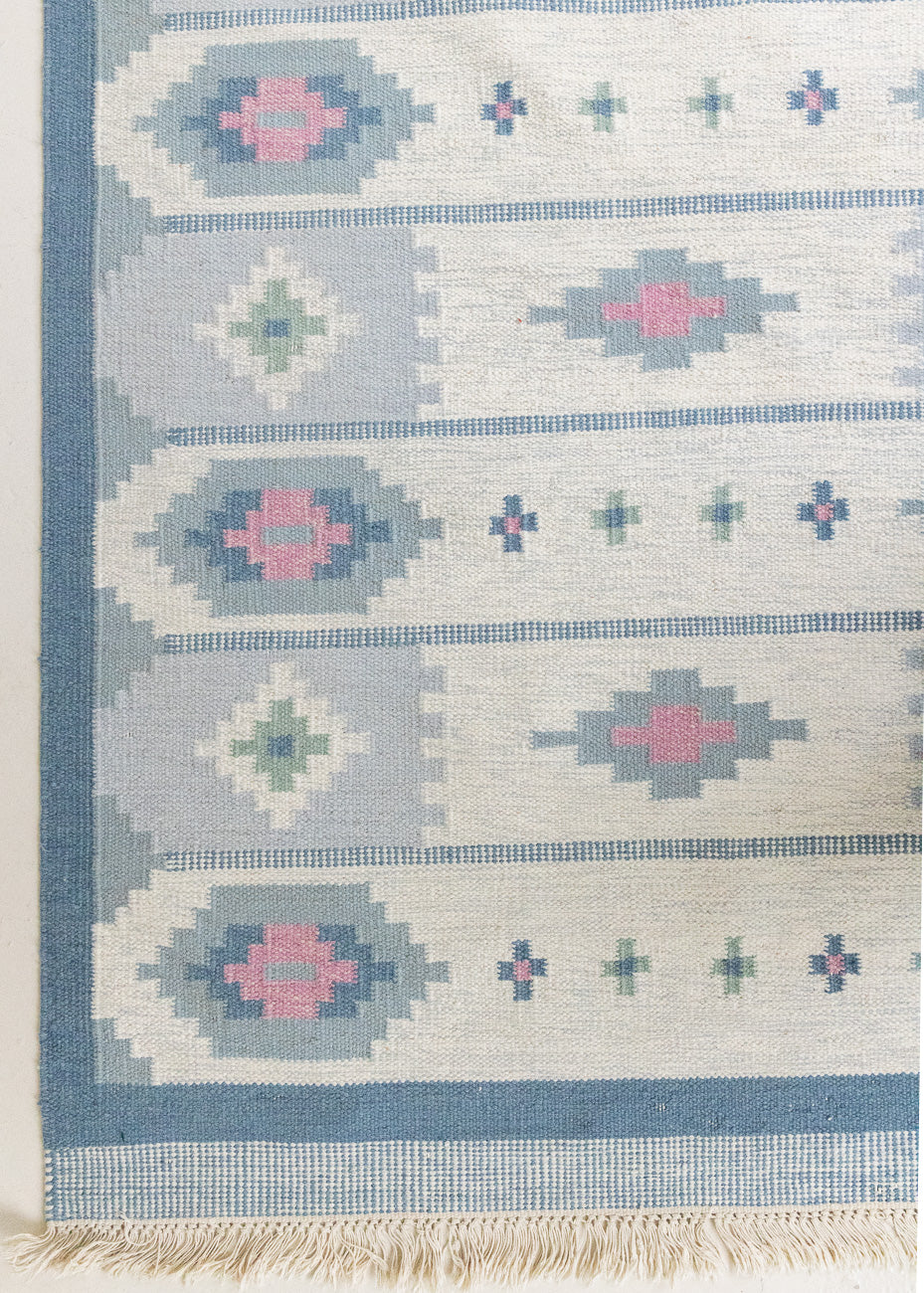 This rug shows beautiful tones of blue, this vintage kilim is featuring bold geometric design with hints of pink within the motifs in the carpet. 