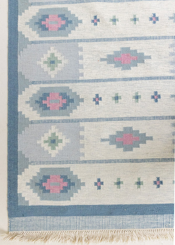 This rug shows beautiful tones of blue, this vintage kilim is featuring bold geometric design with hints of pink within the motifs in the carpet. 