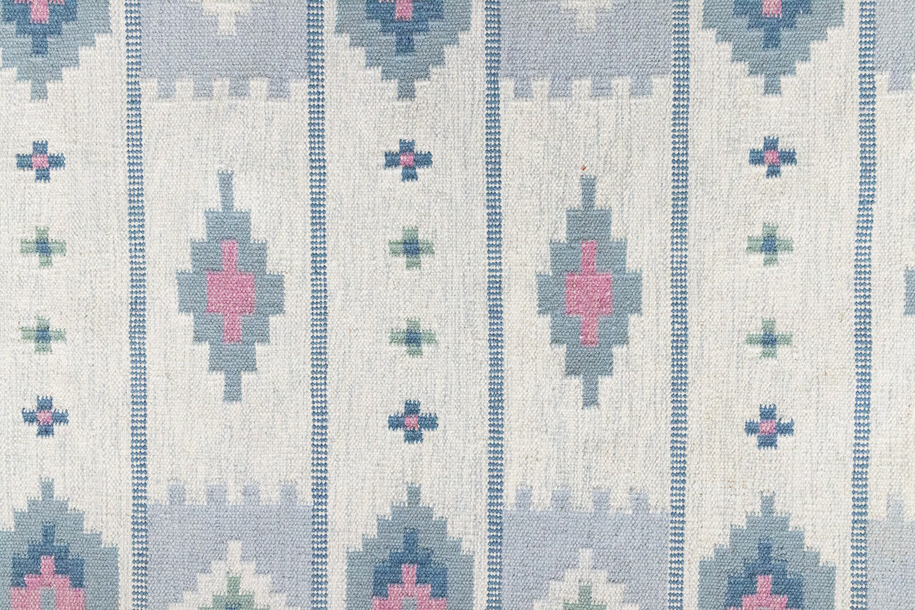 This rug shows beautiful tones of blue, this vintage kilim is featuring bold geometric design with hints of pink within the motifs in the carpet. 