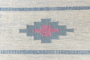 This rug shows beautiful tones of blue, this vintage kilim is featuring bold geometric design with hints of pink within the motifs in the carpet. 