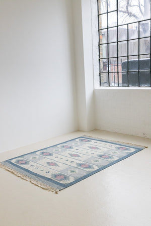 This rug shows beautiful tones of blue, this vintage kilim is featuring bold geometric design with hints of pink within the motifs in the carpet. 