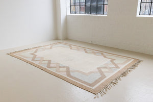 This is an original Swedish röllakan rug handwoven by the mid-century textile designer Anna Johanna Angström. Featuring a geometric patterned rug with pastel colors on a neutral background