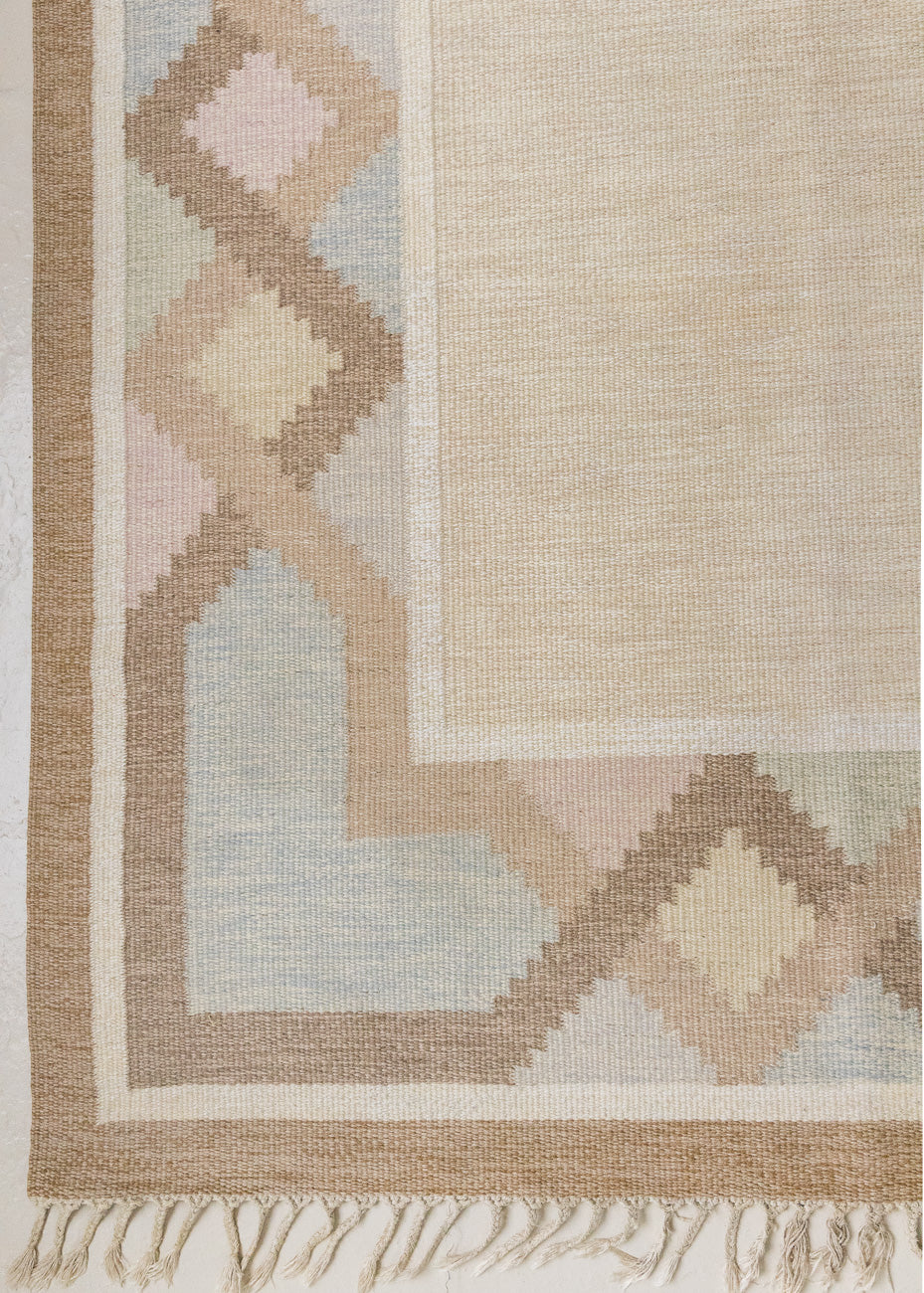 This is an original Swedish röllakan rug handwoven by the mid-century textile designer Anna Johanna Angström. Featuring a geometric patterned rug with pastel colours on a neutral background