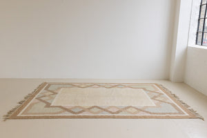 This is an original Swedish röllakan rug handwoven by the mid-century textile designer Anna Johanna Angström. Featuring a geometric patterned rug with pastel colors on a neutral background