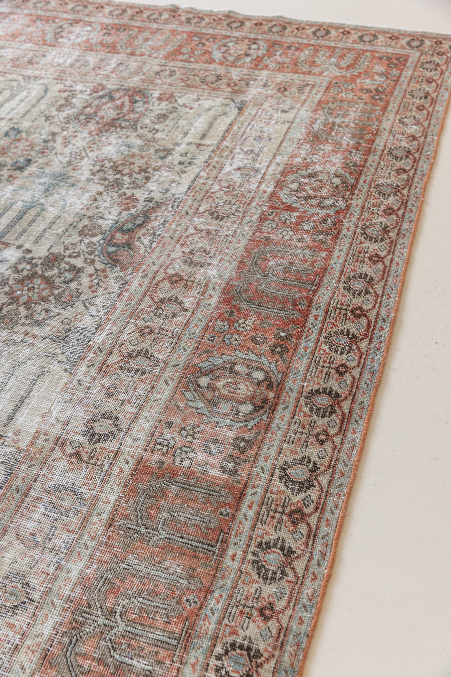 This is a handmade antique Tabriz rug woven in Persia. The Tabriz region is known for producing some of the most ornate Persian carpet, often known for their mesmerising and intricate repeating patterns.