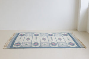 This rug shows beautiful tones of blue, this vintage kilim is featuring bold geometric design with hints of pink within the motifs in the carpet. 