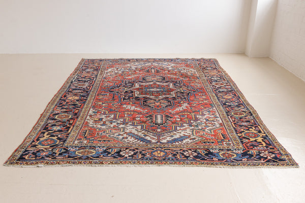This a Vintage Persian Rug from Heriz in Persia. This hand woven Carpet features a lovely red ground with a central medallion design.