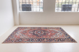This a Vintage Persian Rug from Heriz in Persia. This hand woven Carpet features a lovely red ground with a central medallion design.