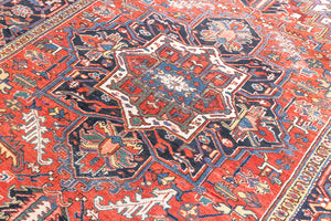 This a Vintage Persian Rug from Heriz in Persia. This hand woven Carpet features a lovely red ground with a central medallion design.