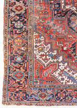 This a Vintage Persian Rug from Heriz in Persia. This hand woven Carpet features a lovely red ground with a central medallion design.