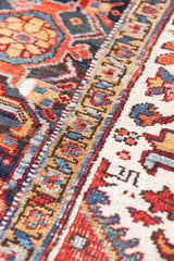 This a Vintage Persian Rug from Heriz in Persia. This hand woven Carpet features a lovely red ground with a central medallion design.