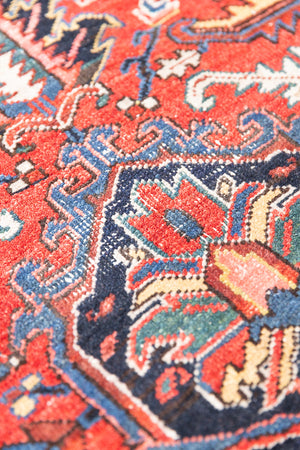 This a Vintage Persian Rug from Heriz in Persia. This hand woven Carpet features a lovely red ground with a central medallion design.