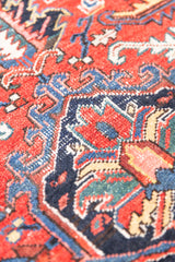 This a Vintage Persian Rug from Heriz in Persia. This hand woven Carpet features a lovely red ground with a central medallion design.