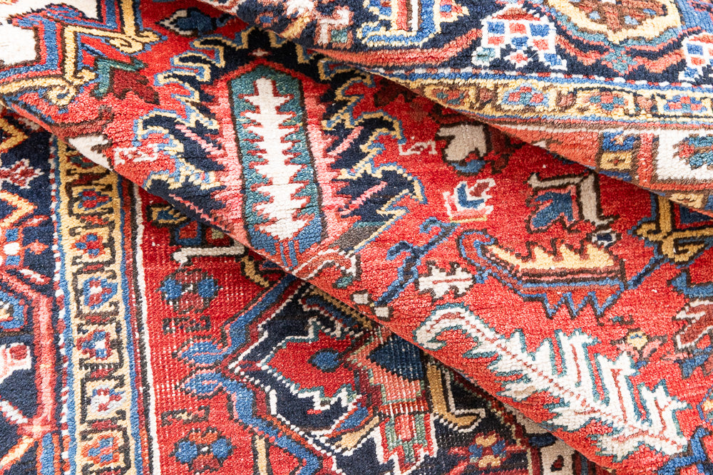 This a Vintage Persian Rug from Heriz in Persia. This hand woven Carpet features a lovely red ground with a central medallion design.