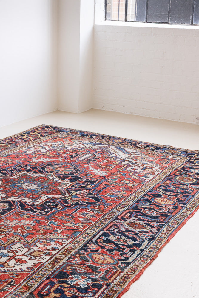 This a Vintage Persian Rug from Heriz in Persia. This hand woven Carpet features a lovely red ground with a central medallion design.