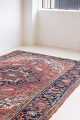 This a Vintage Persian Rug from Heriz in Persia. This hand woven Carpet features a lovely red ground with a central medallion design.