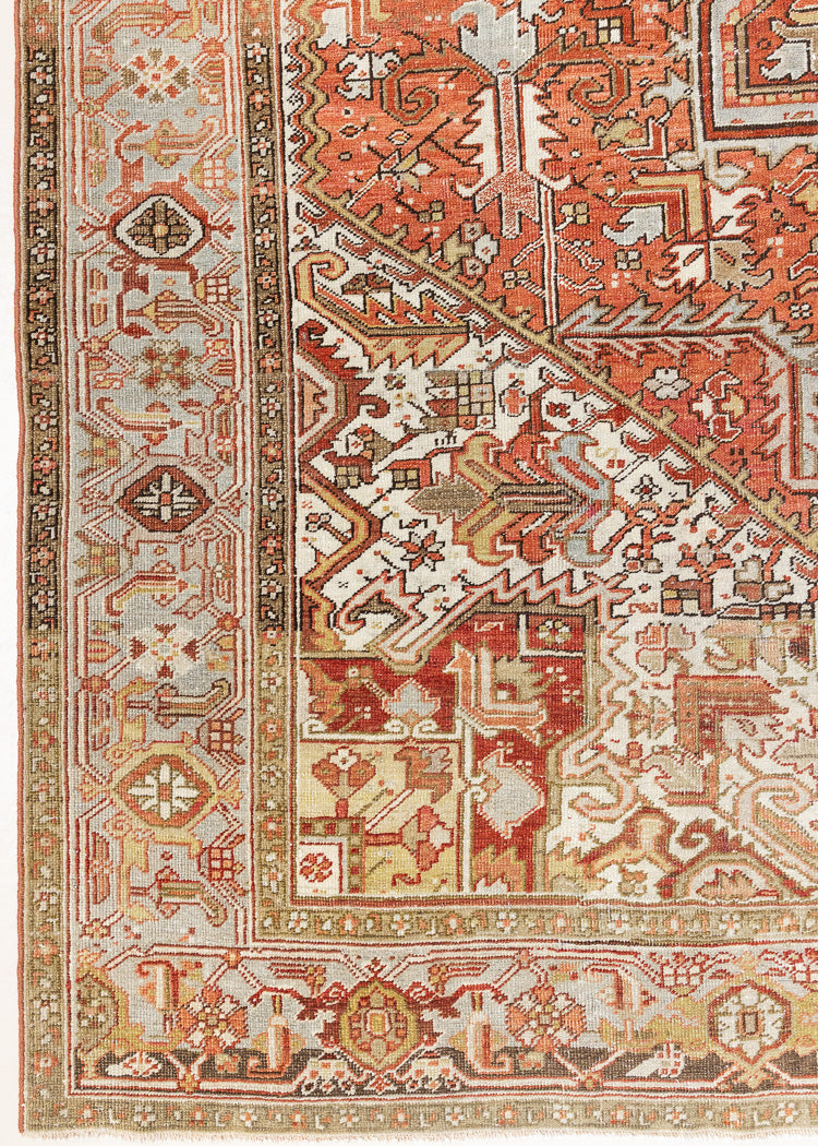 Lainey showcases a classic Heriz composition, centred around a striking medallion set against a soft rust-coloured field, complemented by a light khaki-toned border. Traditional palmette and floral motifs are interpreted through bold, geometric patterns.