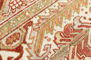 Lainey showcases a classic Heriz composition, centred around a striking medallion set against a soft rust-coloured field, complemented by a light khaki-toned border. Traditional palmette and floral motifs are interpreted through bold, geometric patterns.