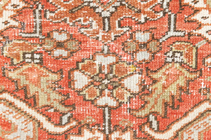 This a Vintage Persian Rug from Heriz in Persia. This hand woven Carpet features a lovely rust red and khaki green colour palette with a central medallion design.