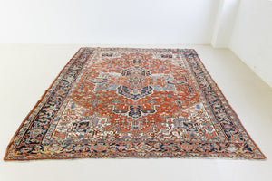 This a Vintage Persian Rug from Heriz in Persia. This hand woven Carpet features a lovely red ground with a central medallion design.