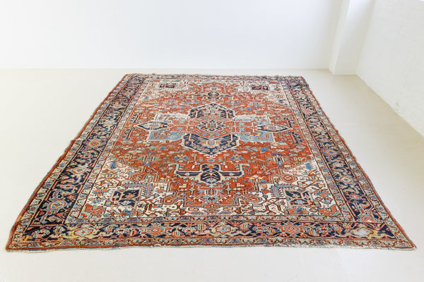This a Vintage Persian Rug from Heriz in Persia. This hand woven Carpet features a lovely red ground with a central medallion design.