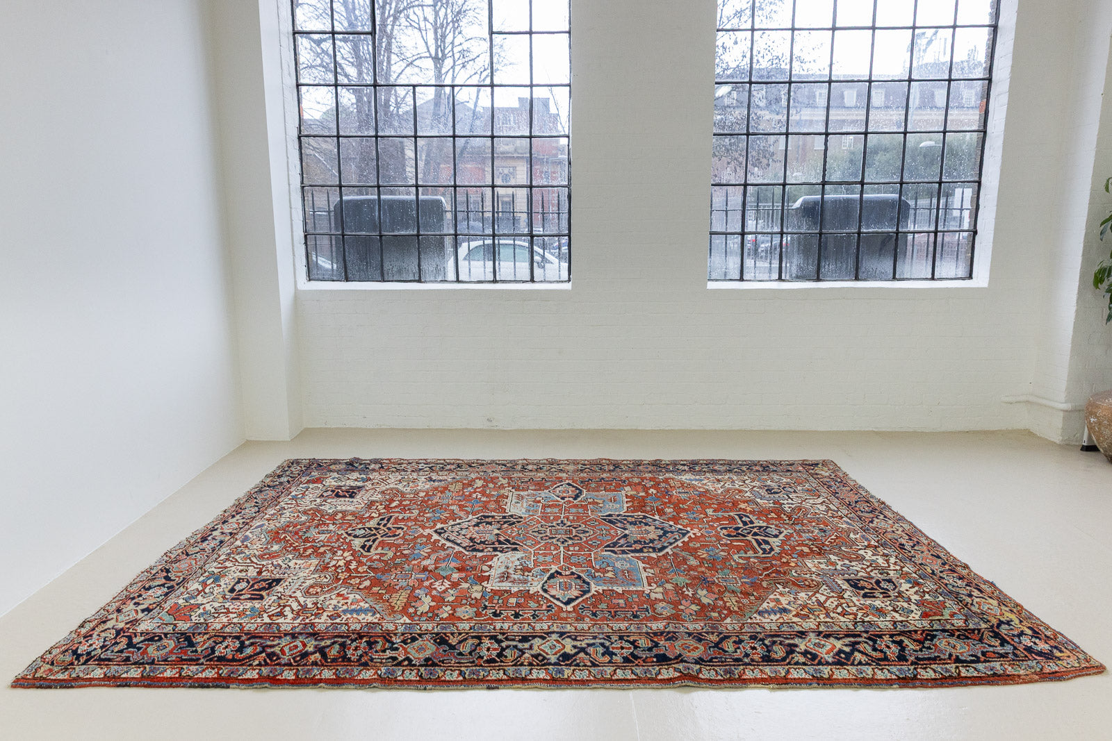 This a Vintage Persian Rug from Heriz in Persia. This hand woven Carpet features a lovely red ground with a central medallion design.