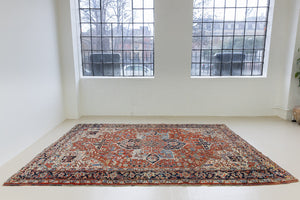 This a Vintage Persian Rug from Heriz in Persia. This hand woven Carpet features a lovely red ground with a central medallion design.