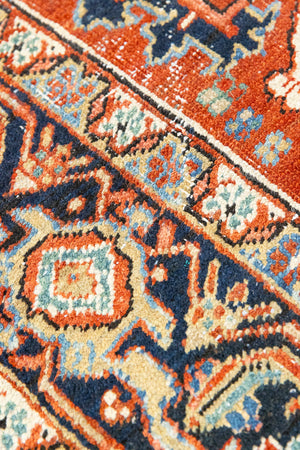 This a Vintage Persian Rug from Heriz in Persia. This hand woven Carpet features a lovely red ground with a central medallion design.