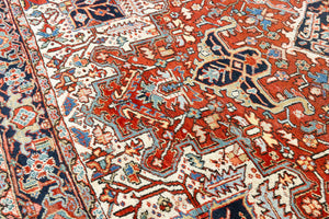 This a Vintage Persian Rug from Heriz in Persia. This hand woven Carpet features a lovely red ground with a central medallion design.